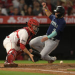 ANAHEIM, CALIFORNIA - JUNE 10: Eugenio Suarez #28 of the Seattle Mariners beats the throw to Matt Thaiss #21 of the Los Angeles Angels to score a run in the fourth inning at Angel Stadium of Anaheim on June 10, 2023 in Anaheim, California. (Photo by Jayne Kamin-Oncea/Getty Images)