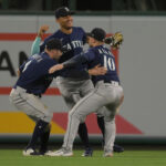 ANAHEIM, CALIFORNIA - JUNE 10: AJ Pollock #8 , Julio Rodriguez #44 and Jarred Kelenic #10 of the Seattle Mariners celebrate after the final out of the ninth inning defeating the Los Angeles Angels at Angel Stadium of Anaheim on June 10, 2023 in Anaheim, California. (Photo by Jayne Kamin-Oncea/Getty Images)