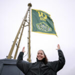 SEATTLE, WASHINGTON - JUNE 09: Sue Bird poses next to her flag, ahead of her Seattle Storm jersey retirement celebration, at The Space Needle on June 09, 2023 in Seattle, Washington. (Photo by Steph Chambers/Getty Images)