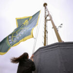 SEATTLE, WASHINGTON - JUNE 09: Sue Bird raises her flag, ahead of her Seattle Storm jersey retirement celebration, at The Space Needle on June 09, 2023 in Seattle, Washington. (Photo by Steph Chambers/Getty Images)