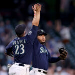 SEATTLE, WASHINGTON - JUNE 12: Ty France #23 and Eugenio Suarez #28 of the Seattle Mariners celebrate their 8-1 win against the Miami Marlins at T-Mobile Park on June 12, 2023 in Seattle, Washington. (Photo by Steph Chambers/Getty Images)