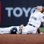 SEATTLE, WASHINGTON - JUNE 26: Jarred Kelenic #10 of the Seattle Mariners reacts after his steal of second base, which was initially ruled an out, was overturned during the fifth inning against the Washington Nationals at T-Mobile Park on June 26, 2023 in Seattle, Washington. (Photo by Steph Chambers/Getty Images)