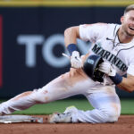 SEATTLE, WASHINGTON - JUNE 26: Jarred Kelenic #10 of the Seattle Mariners reacts after his steal of second base, which was initially ruled an out, was overturned during the fifth inning against the Washington Nationals at T-Mobile Park on June 26, 2023 in Seattle, Washington. (Photo by Steph Chambers/Getty Images)