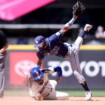 SEATTLE, WASHINGTON - JULY 02: Vidal Brujan #7 of the Tampa Bay Rays falls over J.P. Crawford #3 of the Seattle Mariners at second base for the out during the sixth inning at T-Mobile Park on July 02, 2023 in Seattle, Washington. (Photo by Steph Chambers/Getty Images)