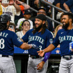HOUSTON, TEXAS - JULY 06: Eugenio Suarez #28 of the Seattle Mariners celebrates with J.P. Crawford #3 and Teoscar Hernandez #35 after hitting a two-run home run in the second inning against the Houston Astros at Minute Maid Park on July 06, 2023 in Houston, Texas. (Photo by Logan Riely/Getty Images)