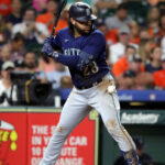 HOUSTON, TEXAS - JULY 07: Ty France #23 of the Seattle Mariners is hit by a pitch in the fourth inning against the Houston Astros at Minute Maid Park on July 07, 2023 in Houston, Texas. (Photo by Bob Levey/Getty Images)