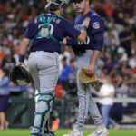 HOUSTON, TEXAS - JULY 07: Tayler Saucedo #60 of the Seattle Mariners and Cal Raleigh #29 shake hands after defeating the Houston Astros at Minute Maid Park on July 07, 2023 in Houston, Texas. (Photo by Bob Levey/Getty Images)