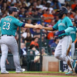HOUSTON, TEXAS - JULY 09: Ty France #23 of the Seattle Mariners and Teoscar Hernandez #35 score in the fourth inning on a double by Jarred Kelenic #10 against the Houston Astros at Minute Maid Park on July 09, 2023 in Houston, Texas. (Photo by Bob Levey/Getty Images)