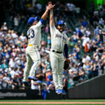 SEATTLE, WASHINGTON - JULY 16: Ty France #23 and Eugenio Suarez #28 of the Seattle Mariners high-five after a 2-0 win over the Detroit Tigers at T-Mobile Park on July 16, 2023 in Seattle, Washington.  (Photo by Alika Jenner/Getty Images)