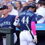 SEATTLE, WASHINGTON - JULY 17: Manager Scott Servais #9 pats Julio Rodriguez #44 of the Seattle Mariners after his strikeout during the first inning against the Minnesota Twins at T-Mobile Park on July 17, 2023 in Seattle, Washington. (Photo by Steph Chambers/Getty Images)
