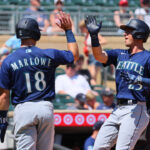 MINNEAPOLIS, MINNESOTA - JULY 26: Dylan Moore #25 and Cade Marlowe #18 of the Seattle Mariners celebrate Moore's three run homer against the Minnesota Twins in the fifth inning at Target Field on July 26, 2023 in Minneapolis, Minnesota. (Photo by Adam Bettcher/Getty Images)