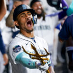 Seattle Mariners' Julio Rodriguez points a trident in the dugout as he celebrates a two-run home run to score J.P. Crawford against the Oakland Athletics during the fourth inning of a baseball game, Monday, Aug. 28, 2023, in Seattle. (AP Photo/Lindsey Wasson)Credit: ASSOCIATED PRESS
