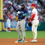 ANAHEIM, CALIFORNIA - AUGUST 4: Teoscar Hernandez #35 of the Seattle Mariners reacts after hitting a double alongside Brandon Drury #23 of the Los Angeles Angels during the third inning at Angel Stadium of Anaheim on August 4, 2023 in Anaheim, California. (Photo by Kevork Djansezian/Getty Images)