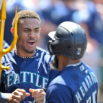 ANAHEIM, CALIFORNIA - AUGUST 6: Teoscar Hernandez #35 of the Seattle Mariners is congratulated by Julio Rodriguez #44 in the dugout after hitting a solo home run in the seventh inning against the Los Angeles Angels at Angel Stadium of Anaheim on August 6, 2023 in Anaheim, California. (Photo by Jayne Kamin-Oncea/Getty Images)