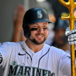 SEATTLE, WASHINGTON - AUGUST 02: Cal Raleigh #29 of the Seattle Mariners celebrates in the dugout with teammates after hitting a two-run home run during the sixth inning against the Boston Red Sox at T-Mobile Park on August 02, 2023 in Seattle, Washington. The Seattle Mariners won 6-3. (Photo by Alika Jenner/Getty Images)