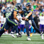 SEATTLE, WASHINGTON - AUGUST 10: Drew Lock #2 of the Seattle Seahawks hands off the ball during the second quarter of the preseason game against the Seattle Seahawks at Lumen Field on August 10, 2023 in Seattle, Washington. (Photo by Jane Gershovich/Getty Images)