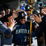 SEATTLE, WASHINGTON - AUGUST 09: Cal Raleigh #29 of the Seattle Mariners celebrates with teammates after hitting a two-run home run during the eighth inning against the San Diego Padres at T-Mobile Park on August 09, 2023 in Seattle, Washington. (Photo by Alika Jenner/Getty Images)