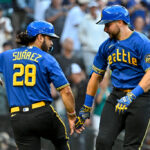 SEATTLE, WASHINGTON - AUGUST 11: Cal Raleigh (R) #29 of the Seattle Mariners celebrates with Eugenio Suarez #28 after hitting a two-run home run during the first inning against the Baltimore Orioles at T-Mobile Park on August 11, 2023 in Seattle, Washington. (Photo by Alika Jenner/Getty Images)