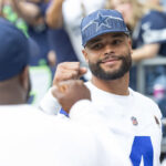 SEATTLE, WASHINGTON - AUGUST 19: Dak Prescott #4 of the Dallas Cowboys cheers teammates on before their preseason game against the Seattle Seahawks at Lumen Field on August 19, 2023 in Seattle, Washington. (Photo by Tom Hauck/Getty Images)