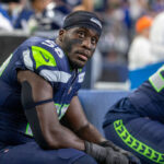 SEATTLE, WASHINGTON - AUGUST 19: Derick Hall #58 of the Seattle Seahawks sits on the bench during a preseason game against the Dallas Cowboys at Lumen Field on August 19, 2023 in Seattle, Washington. (Photo by Tom Hauck/Getty Images)