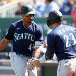 KANSAS CITY, MISSOURI - AUGUST 17:  Julio Rodriguez #44 of the Seattle Mariners is congratulated by Ty France #23 after hitting a 3-run home run during the 8th inning of the game against the Kansas City Royals at Kauffman Stadium on August 17, 2023 in Kansas City, Missouri. (Photo by Jamie Squire/Getty Images)