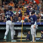 HOUSTON, TEXAS - AUGUST 18: Julio Rodriguez #44 of the Seattle Mariners receives congratulations from Teoscar Hernandez #35 after hitting a home run in the third inning against the Houston Astros at Minute Maid Park on August 18, 2023 in Houston, Texas. (Photo by Bob Levey/Getty Images)