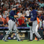 HOUSTON, TEXAS - AUGUST 18: Catcher Cal Raleigh #29 of the Seattle Mariners shakes hands with Andres Munoz #75 after defeating the Houston Astros at Minute Maid Park on August 18, 2023 in Houston, Texas. (Photo by Bob Levey/Getty Images)