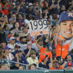 HOUSTON, TEXAS - AUGUST 19: Fans cheer as Jose Altuve #27 of the Houston Astros singles in the first inning against the Seattle Mariners at Minute Maid Park on August 19, 2023 in Houston, Texas. The single was Altuve's 1999 career hit. (Photo by Bob Levey/Getty Images)