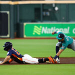 HOUSTON, TEXAS - AUGUST 20: Jose Altuve #27 of the Houston Astros steals second base as Josh Rojas #4 of the Seattle Mariners applies the tag in the first inning at Minute Maid Park on August 20, 2023 in Houston, Texas. (Photo by Bob Levey/Getty Images)