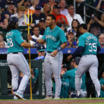 HOUSTON, TEXAS - AUGUST 20: Eugenio Suarez #28 of the Seattle Mariners is congratulated by Julio Rodriguez #44 after hitting a two-run home run in the second inning against the Houston Astros at Minute Maid Park on August 20, 2023 in Houston, Texas. (Photo by Bob Levey/Getty Images)