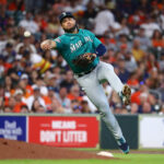 HOUSTON, TEXAS - AUGUST 20: Eugenio Suarez #28 of the Seattle Mariners throws to first base in an attempt to retire Chas McCormick #20 of the Houston Astros in the second inning at Minute Maid Park on August 20, 2023 in Houston, Texas. McCormick was safe on the play. (Photo by Bob Levey/Getty Images)