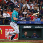 HOUSTON, TEXAS - AUGUST 20: Dylan Moore #25 of the Seattle Mariners singles in a run in the fifth inning against the Houston Astros at Minute Maid Park on August 20, 2023 in Houston, Texas. (Photo by Bob Levey/Getty Images)