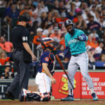 HOUSTON, TEXAS - AUGUST 20: Teoscar Hernandez #35 of the Seattle Mariners argues with home plate umpire Stu Scheurwater #85 after he was called out on strikes in the sixth inning against the Houston Astros at Minute Maid Park on August 20, 2023 in Houston, Texas. (Photo by Bob Levey/Getty Images)