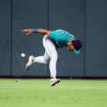 HOUSTON, TEXAS - AUGUST 20: Julio Rodriguez #44 of the Seattle Mariners drops the ball attempting to catch a line drive by Jeremy Pena #3 of the Houston Astros in the sixth inning at Minute Maid Park on August 20, 2023 in Houston, Texas. (Photo by Bob Levey/Getty Images)