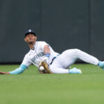 SEATTLE, WA - AUGUST 28:  Centerfielder Julio Rodriguez #44 of the Seattle Mariners is unable to make a sliding catch on a ball hit by Zack Gelof #20 of the Oakland Athletics at T-Mobile Park on August 28, 2023 in Seattle, Washington. (Photo by Stephen Brashear/Getty Images)