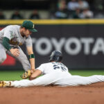 SEATTLE, WA - AUGUST 28: Shortstop Nick Allen #2 of the Oakland Athletics tags out Dylan Moore #25 of the Seattle Mariners as he tries to steal second base during the second inning of a game at T-Mobile Park on August 28, 2023 in Seattle, Washington. (Photo by Stephen Brashear/Getty Images)