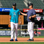 SEATTLE, WASHINGTON - AUGUST 25: Julio Rodriguez #44 of the Seattle Mariners and head coach Scott Servais #9 talk before the game against the Kansas City Royals at T-Mobile Park on August 25, 2023 in Seattle, Washington. (Photo by Alika Jenner/Getty Images)