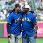 SEATTLE, WASHINGTON - AUGUST 25: Former Seattle Seahawk Richard Sherman hugs MLB Hall of Fame member Ken Griffey Jr. before throwing out the ceremonial first pitch before the game between the Seattle Mariners and the Kansas City Royals at T-Mobile Park on August 25, 2023 in Seattle, Washington. (Photo by Alika Jenner/Getty Images)