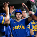 SEATTLE, WASHINGTON - AUGUST 25: Dominic Canzone #8 of the Seattle Mariners celebrates with teammates in the dugout after scoring during the fifth inning against the Kansas City Royals at T-Mobile Park on August 25, 2023 in Seattle, Washington. (Photo by Alika Jenner/Getty Images)