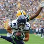 GREEN BAY, WISCONSIN - AUGUST 26: Jake Bobo #19 of the Seattle Seahawks catches a pass for a touchdown in front of Innis Gaines #38 of the Green Bay Packers during the second quarter of a preseason game at Lambeau Field on August 26, 2023 in Green Bay, Wisconsin. (Photo by Stacy Revere/Getty Images)