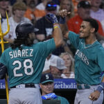 Seattle Mariners' Eugenio Suarez celebrates with Julio Rodriguez after hitting a two run home run during the second inning of a baseball game against the Houston Astros, Sunday, Aug. 20, 2023, in Houston. (AP Photo/Kevin M. Cox)Credit: ASSOCIATED PRESS