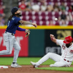 CINCINNATI, OHIO - SEPTEMBER 06: J.P. Crawford #3 of the Seattle Mariners turns a double play past Nick Martini #23 of the Cincinnati Reds in the eighth inning at Great American Ball Park on September 06, 2023 in Cincinnati, Ohio. (Photo by Dylan Buell/Getty Images)