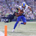 SEATTLE, WASHINGTON - SEPTEMBER 10:  Puka Nacua #17 of the Los Angeles Rams is tackled by Tre Brown #22 of the Seattle Seahawks after a reception during the first half at Lumen Field on September 10, 2023 in Seattle, Washington. (Photo by Steph Chambers/Getty Images)