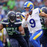 SEATTLE, WASHINGTON - SEPTEMBER 10:  Matthew Stafford #9 of the Los Angeles Rams runs the ball against Bobby Wagner #54 of the Seattle Seahawks during the second half at Lumen Field on September 10, 2023 in Seattle, Washington. (Photo by Steph Chambers/Getty Images)