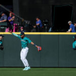 SEATTLE, WASHINGTON - SEPTEMBER 13: Dominic Canzone #8, Julio Rodriguez #44 and Teoscar Hernandez #35 of the Seattle Mariners celebrate their 3-2 win against the Los Angeles Angels at T-Mobile Park on September 13, 2023 in Seattle, Washington. (Photo by Steph Chambers/Getty Images)