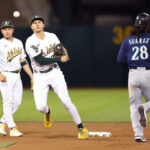 OAKLAND, CALIFORNIA - SEPTEMBER 18: Zack Gelof #20 of the Oakland Athletics turns a double play Eugenio Suarez #28 of the Seattle Mariners is forced out at second base in the second inning at RingCentral Coliseum on September 18, 2023 in Oakland, California. (Photo by Ezra Shaw/Getty Images)