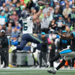SEATTLE, WASHINGTON - SEPTEMBER 24: Tyler Lockett #16 of the Seattle Seahawks catches a pass in front of Vonn Bell #24 of the Carolina Panthers during the second quarter at Lumen Field on September 24, 2023 in Seattle, Washington. (Photo by Christopher Mast/Getty Images)