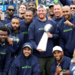 SEATTLE, WASHINGTON - SEPTEMBER 24: Former Seattle Seahawks players pose for a photo with the Vince Lombardi Trophy during a ceremony honoring the 10th anniversary of their Super Bowl win during a ceremony at halftime of a game against the Carolina Panthers at Lumen Field on September 24, 2023 in Seattle, Washington. (Photo by Christopher Mast/Getty Images)