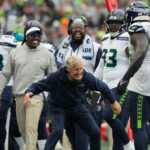 SEATTLE, WASHINGTON - SEPTEMBER 24: Head coach Pete Carroll of the Seattle Seahawks celebrates with Jarran Reed #90 of the Seattle Seahawks during the fourth quarter against the Carolina Panthers at Lumen Field on September 24, 2023 in Seattle, Washington. (Photo by Christopher Mast/Getty Images)