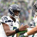 SEATTLE, WASHINGTON - SEPTEMBER 24: Geno Smith #7 of the Seattle Seahawks celebrates with Jake Bobo #19 of the Seattle Seahawks after Bobo's receiving touchdown during the fourth quarter against the Carolina Panthers at Lumen Field on September 24, 2023 in Seattle, Washington. (Photo by Steph Chambers/Getty Images)